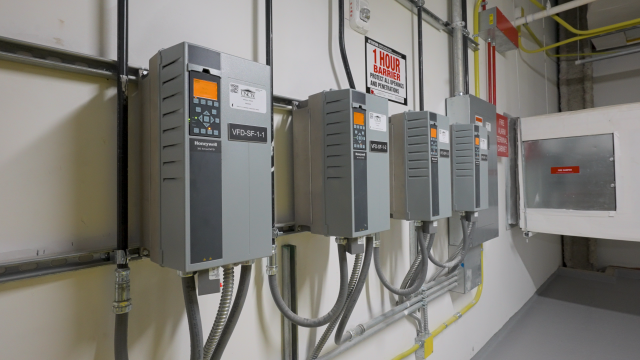 Technician configuring a building automation control panel